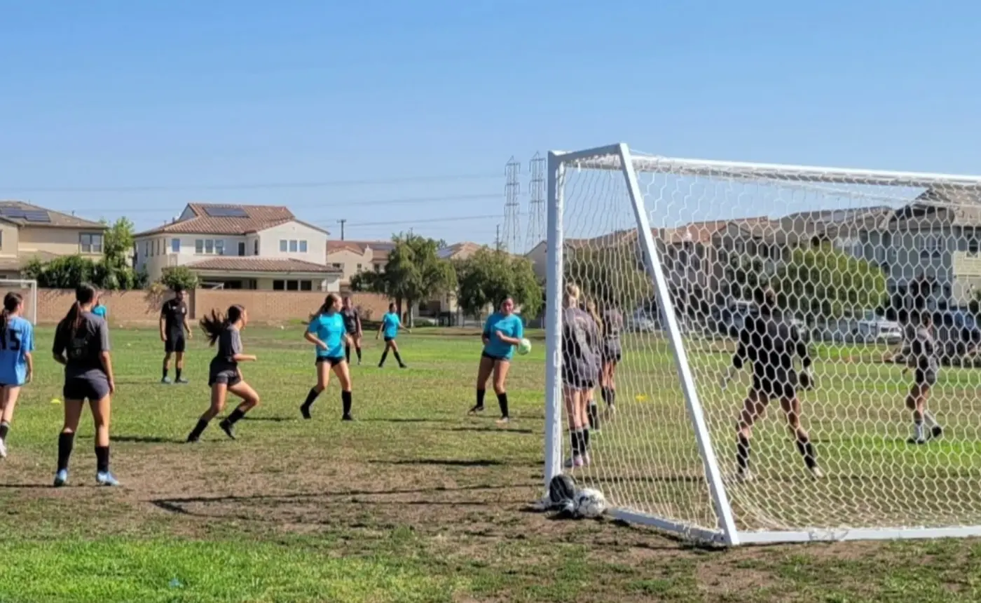Players spread across the pitch during a training scrimmage